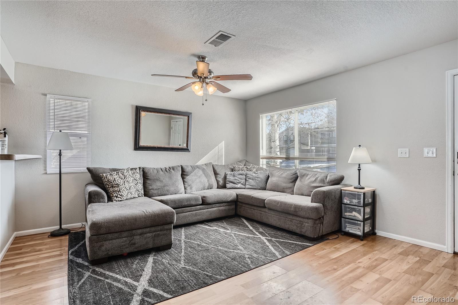 4725 Andes Street Denver, CO 80249 - Photo 5 of 27 a living room with furniture and a large window