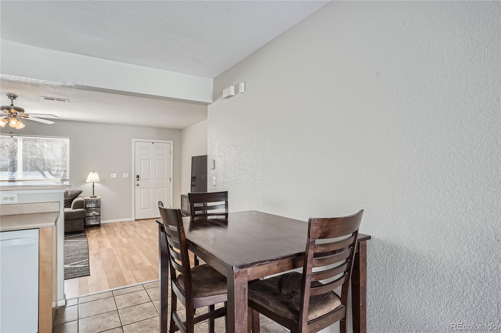4725 Andes Street Denver, CO 80249 - Photo 8 of 27 a view of a dining room with furniture and a chandelier