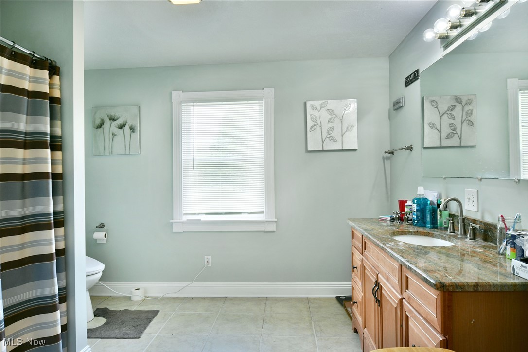 1735 Pleasant Valley Road Girard, OH 44420 - Photo 33 of 44 Full bathroom with vanity, toilet, tile patterned flooring, baseboards, and a shower with shower curtain