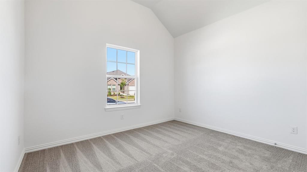 2529 Rivers W Road Anna, TX 75409 - Photo 10 of 40 Interior room featuring a vaulted ceiling and a single window with grid panes
