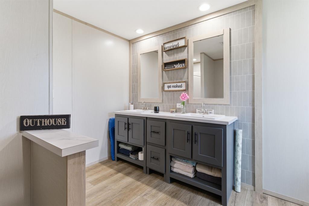 8792 Highway 67 Saltillo, TX 75478 - Photo 27 of 40 a bathroom with a sink double vanity and a mirror