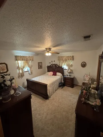 a spacious bedroom with bed and window