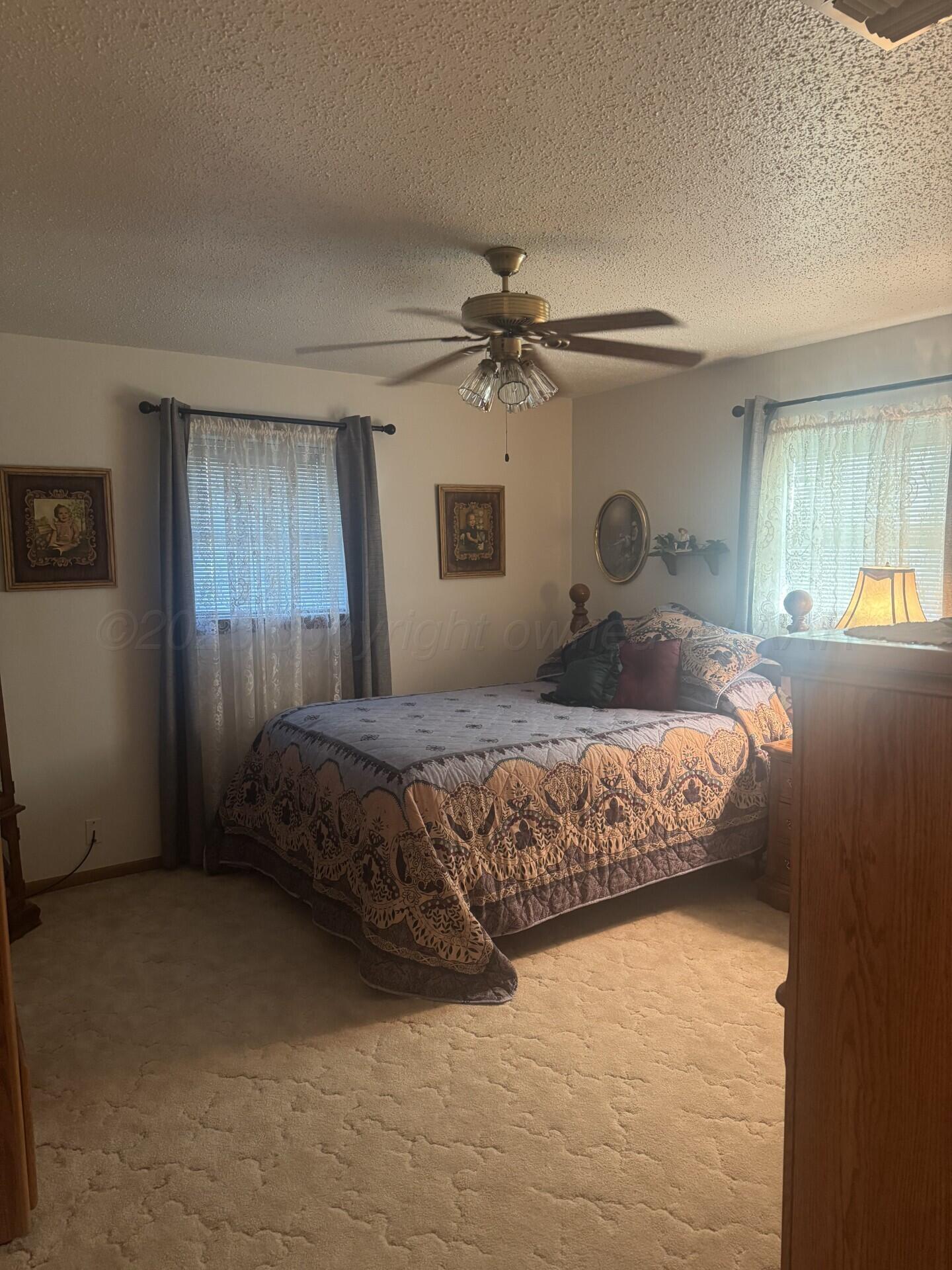 1009 P Avenue Sunray, TX 79086 - Photo 6 of 10 a bedroom with a bed dresser and a window