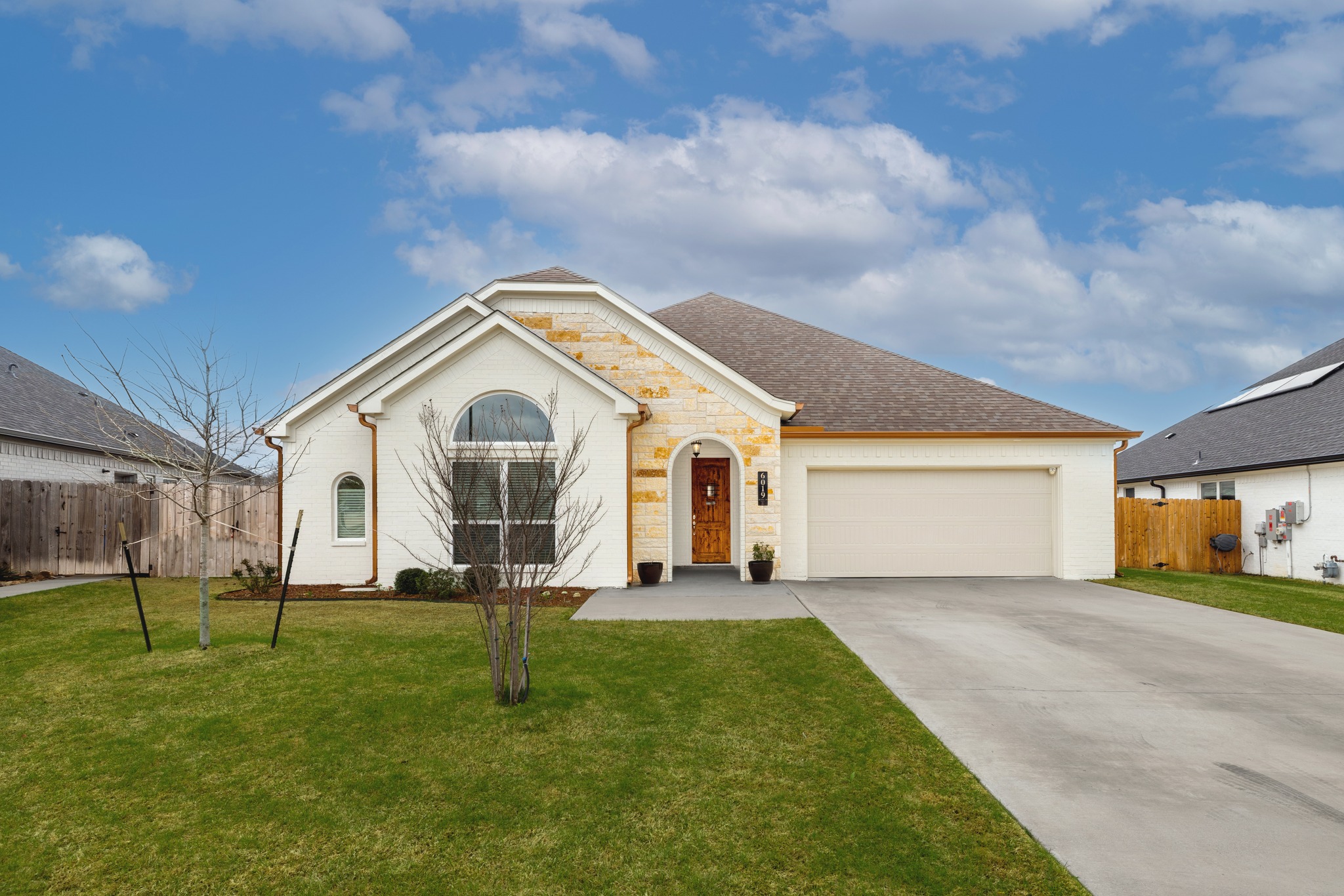 6019 Monza Drive Temple, TX 76502 - Photo 1 of 40 View of front of property featuring an attached garage, concrete driveway, brick siding, and a shingled roof
