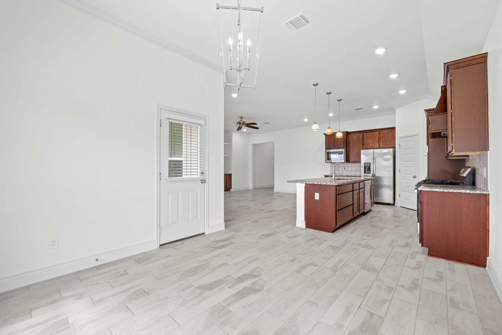 6019 Monza Drive Temple, TX 76502 - Photo 40 of 40 Kitchen with open floor plan, light stone countertops, pendant lighting, stainless steel appliances, and a kitchen island with sink