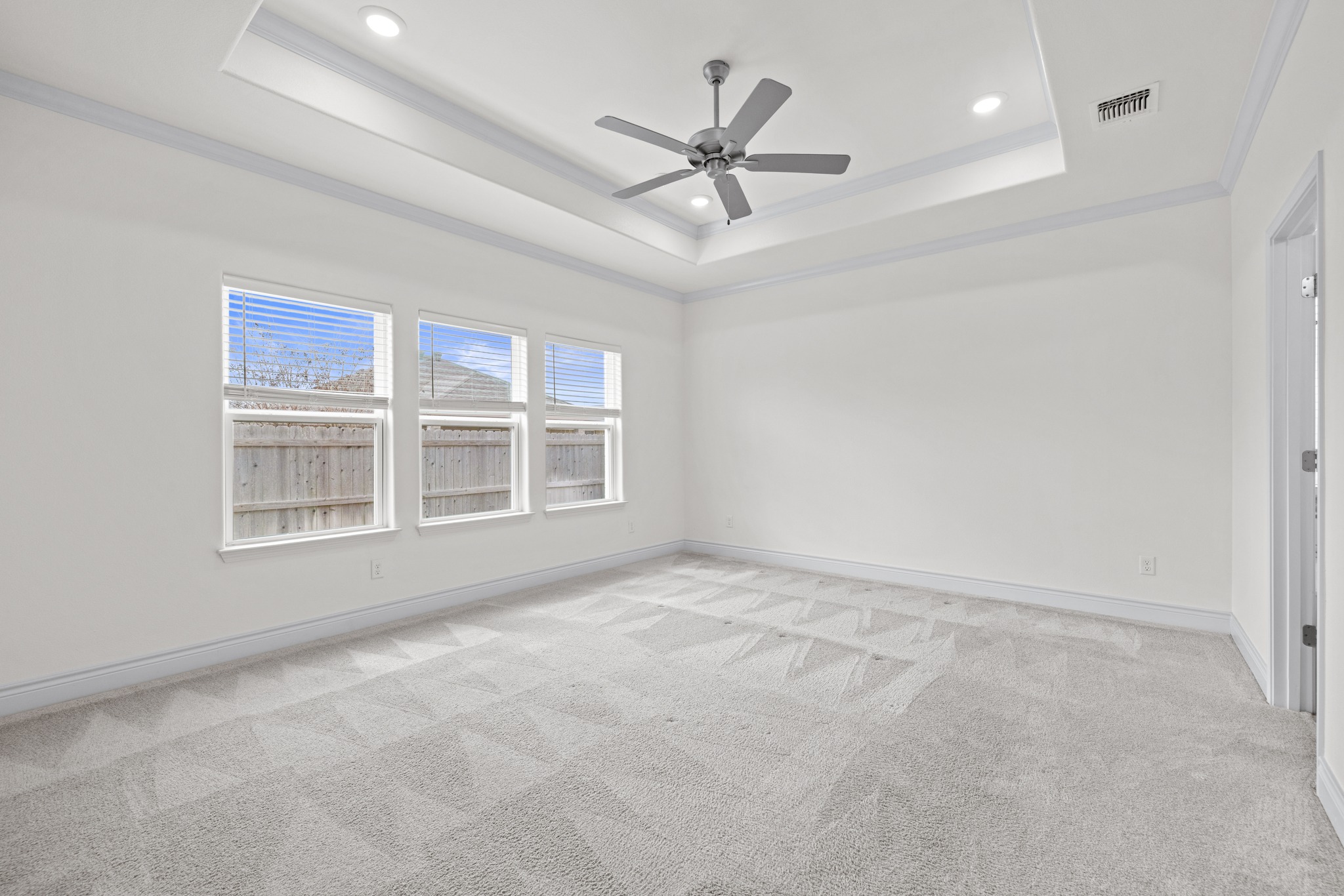 6019 Monza Drive Temple, TX 76502 - Photo 18 of 40 Spare room with light colored carpet, ceiling fan, ornamental molding, and recessed lighting