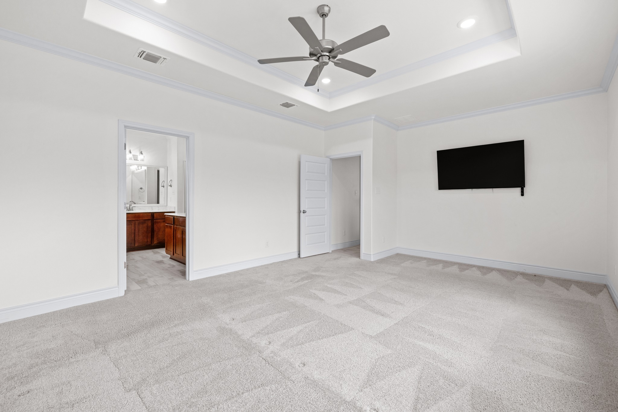 6019 Monza Drive Temple, TX 76502 - Photo 19 of 40 Unfurnished bedroom with light colored carpet, crown molding, a ceiling fan, recessed lighting, and ensuite bathroom