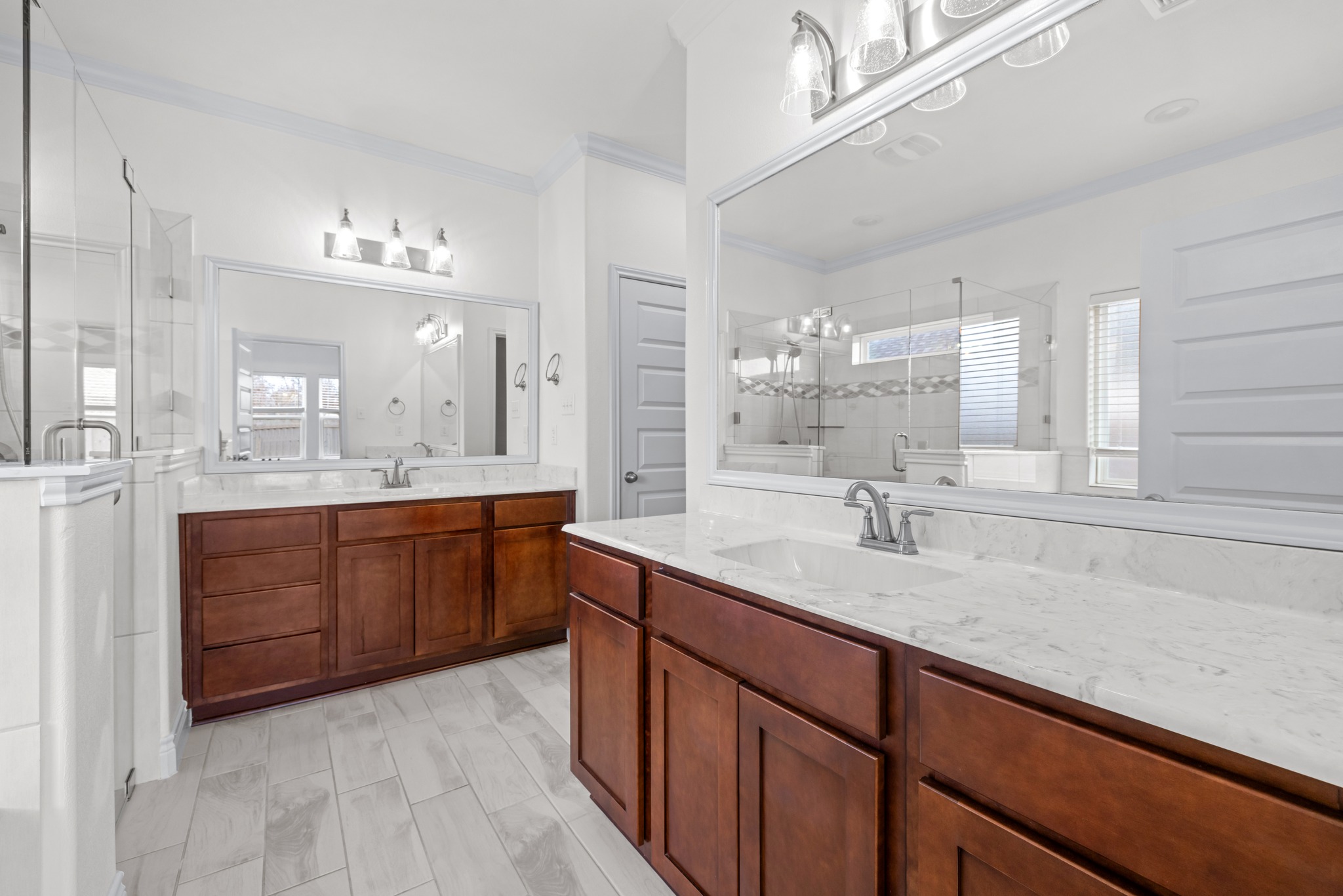6019 Monza Drive Temple, TX 76502 - Photo 20 of 40 Bathroom with a stall shower, two vanities, ornamental molding, and hanging lights