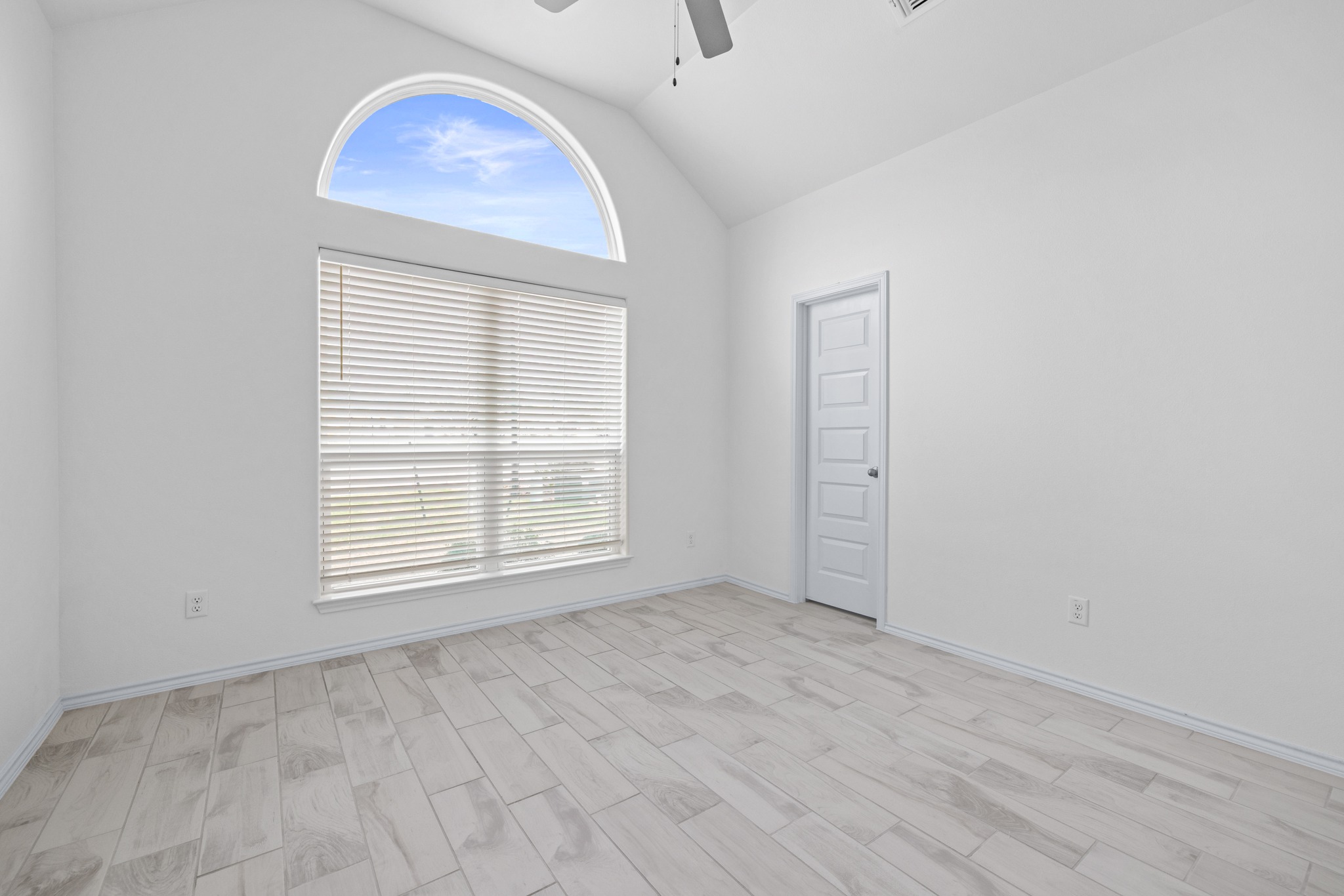 6019 Monza Drive Temple, TX 76502 - Photo 24 of 40 Empty room with ceiling fan, vaulted ceiling, and wood finish floors