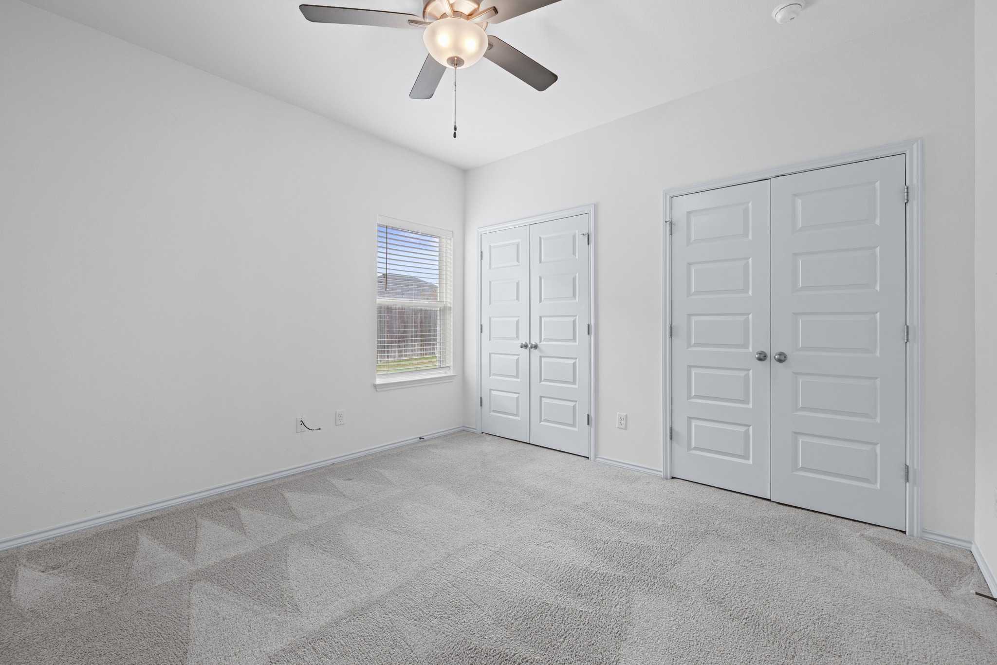 6019 Monza Drive Temple, TX 76502 - Photo 27 of 40 Unfurnished bedroom featuring multiple closets, light colored carpet, and ceiling fan