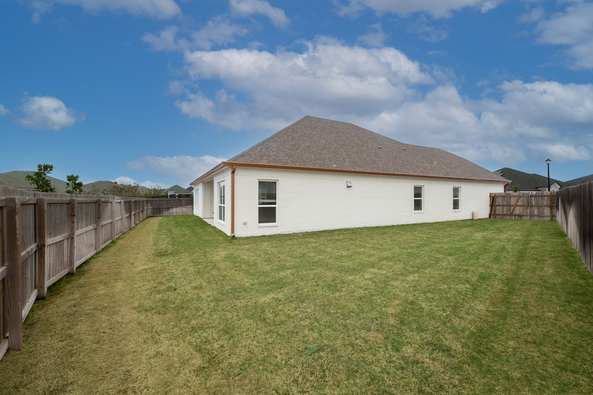 6019 Monza Drive Temple, TX 76502 - Photo 33 of 40 Back of property with a fenced backyard and a shingled roof
