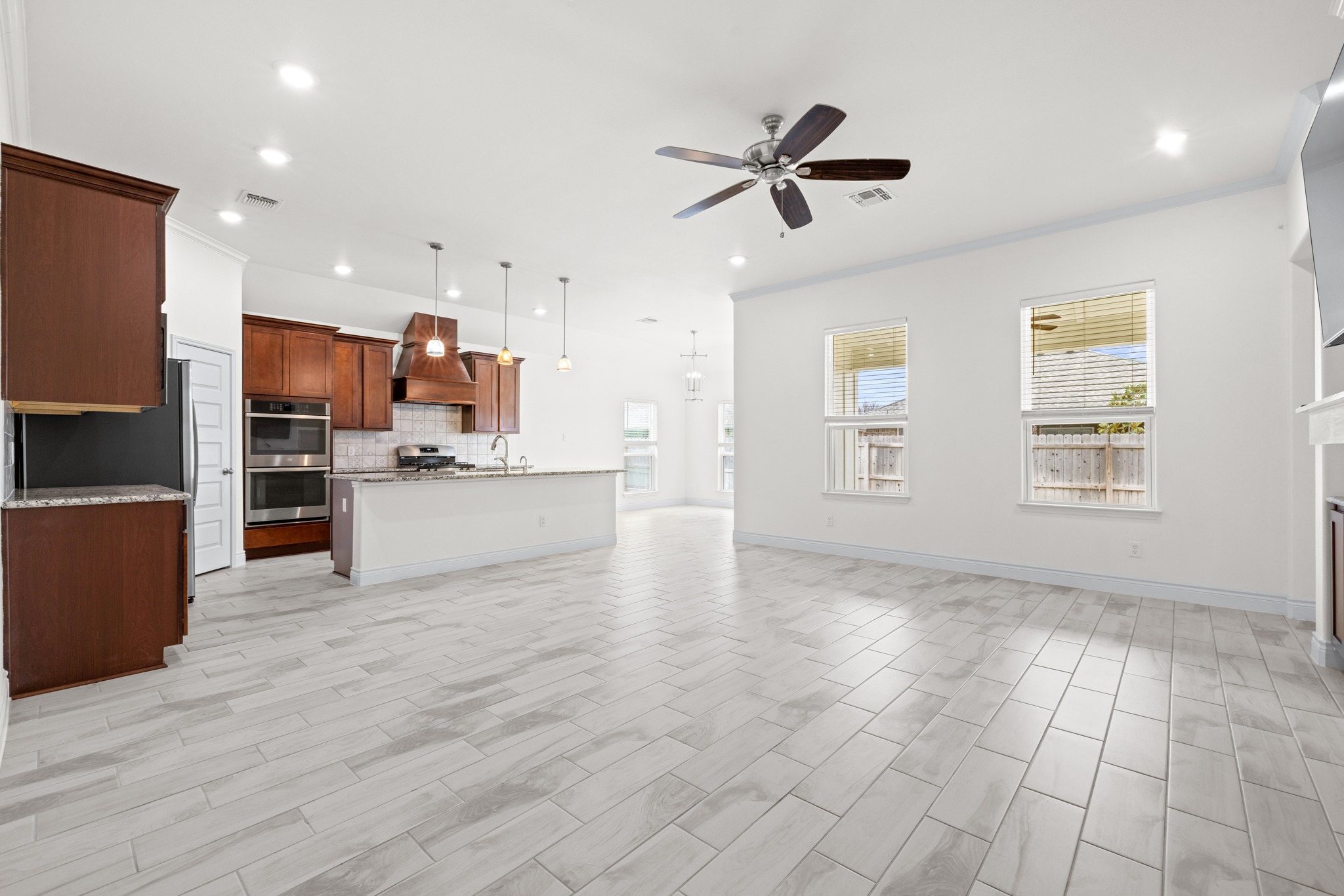 6019 Monza Drive Temple, TX 76502 - Photo 10 of 40 Unfurnished living room with a ceiling fan, crown molding, and recessed lighting