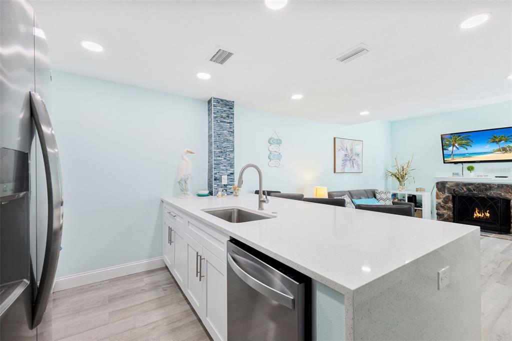337 Rex Place, Unit G Madeira Beach, FL 33708 - Photo 12 of 40 a kitchen with stainless steel appliances a sink and a refrigerator