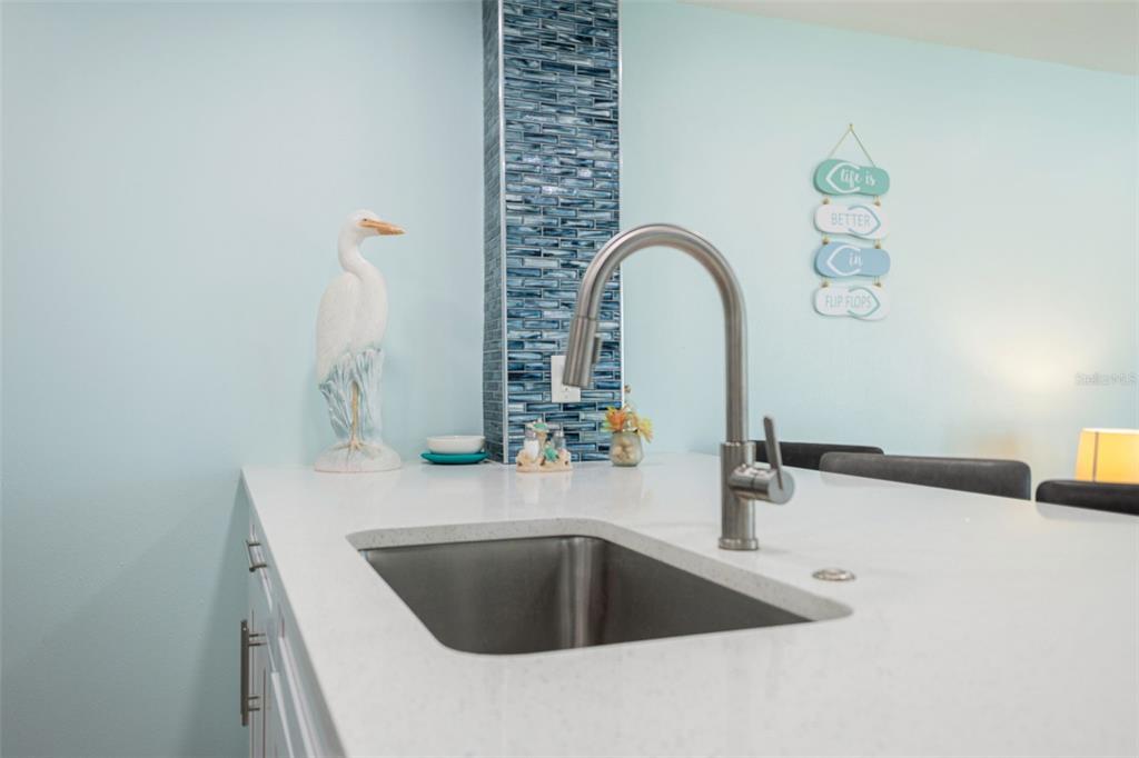 337 Rex Place, Unit G Madeira Beach, FL 33708 - Photo 13 of 40 a kitchen with a sink and a granite top