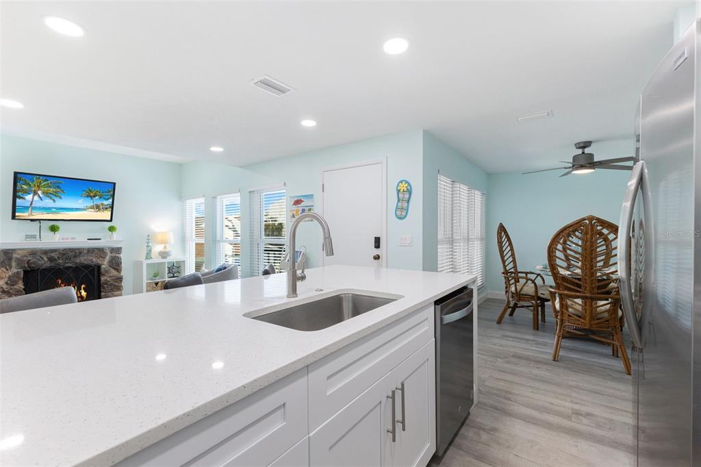337 Rex Place, Unit G Madeira Beach, FL 33708 - Photo 15 of 40 a view of a kitchen counter space with furniture and fireplace