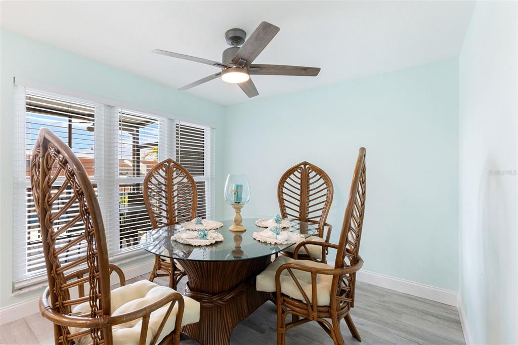 337 Rex Place, Unit G Madeira Beach, FL 33708 - Photo 16 of 40 a view of a dining room with furniture window and wooden floor