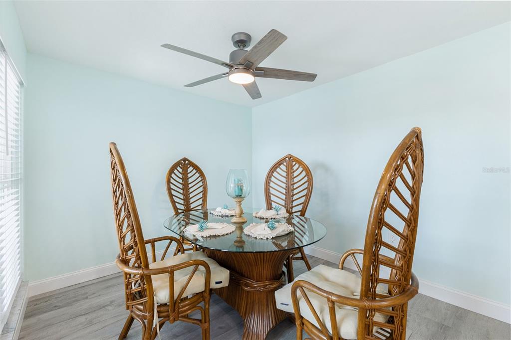 337 Rex Place, Unit G Madeira Beach, FL 33708 - Photo 17 of 40 a view of a dining room with furniture and wooden floor