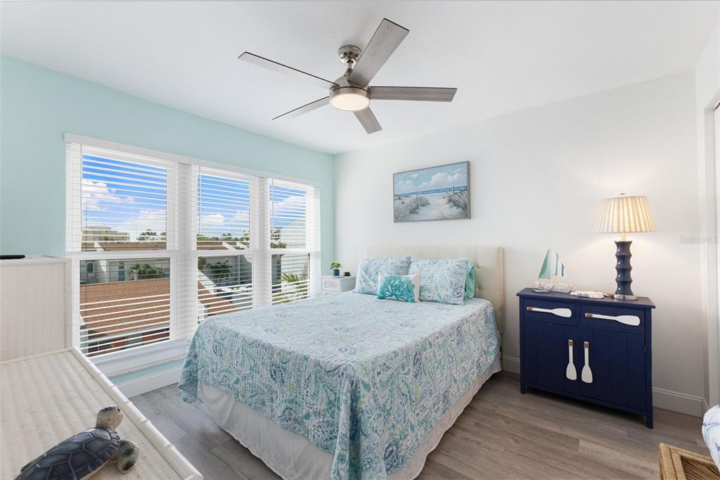 337 Rex Place, Unit G Madeira Beach, FL 33708 - Photo 20 of 40 a bedroom with a bed and a large window