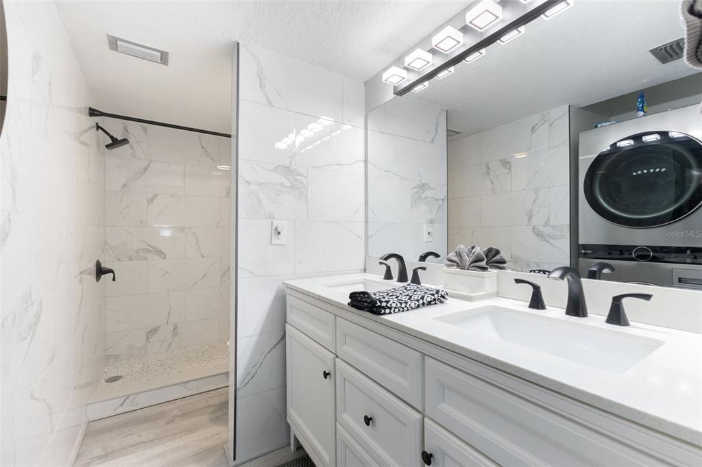 337 Rex Place, Unit G Madeira Beach, FL 33708 - Photo 22 of 40 a bathroom with a sink a toilet and shower