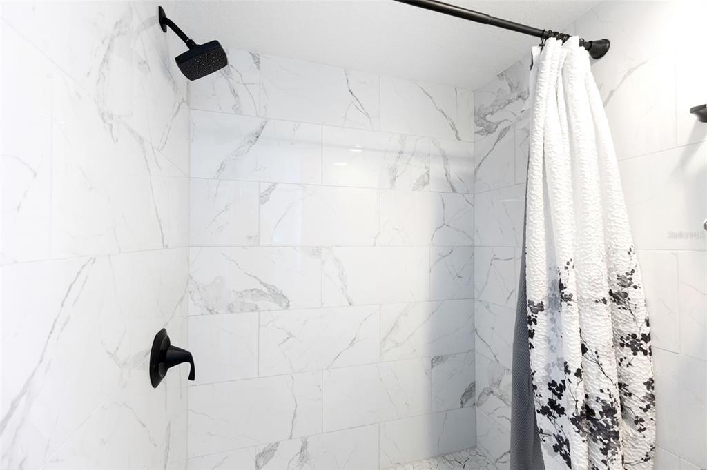 337 Rex Place, Unit G Madeira Beach, FL 33708 - Photo 24 of 40 a bathroom with a shower