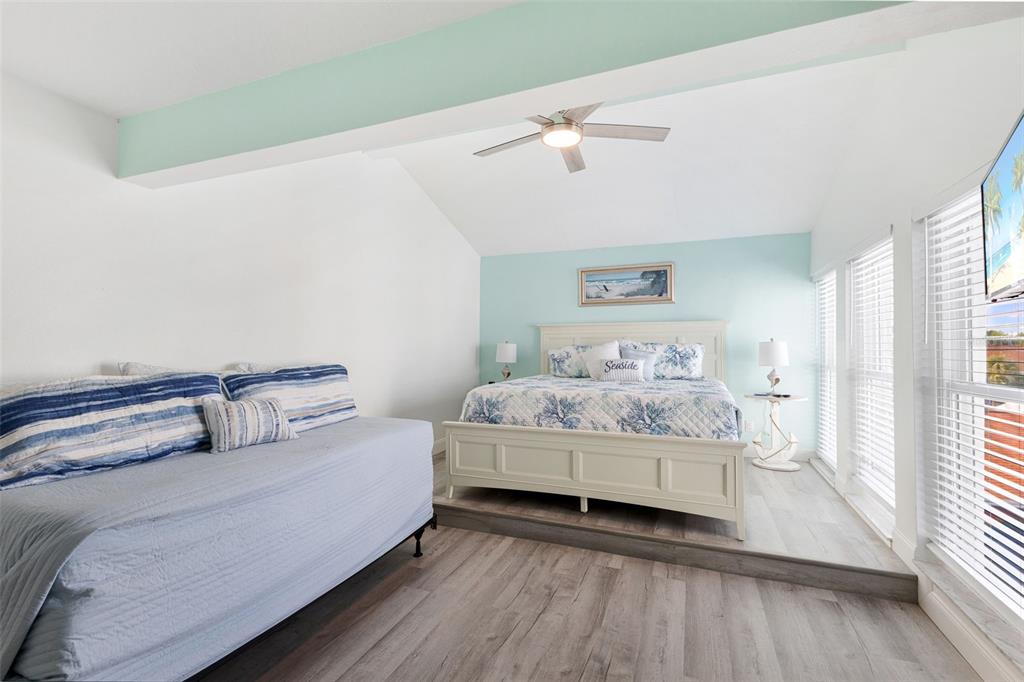 337 Rex Place, Unit G Madeira Beach, FL 33708 - Photo 26 of 40 a bedroom with a bed and a window