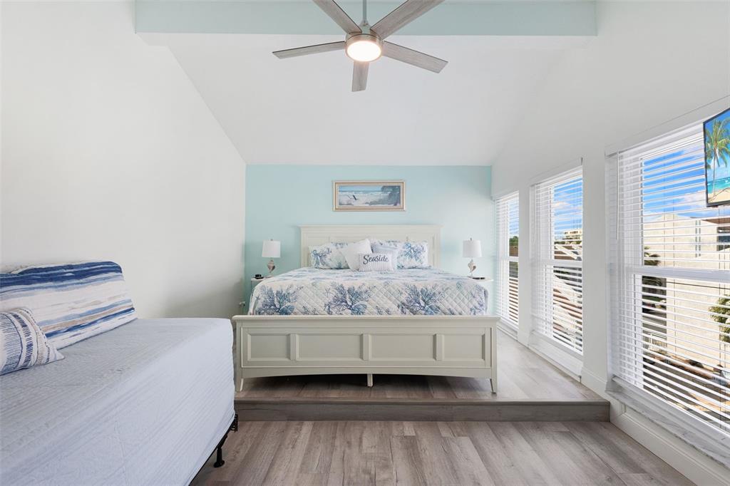 337 Rex Place, Unit G Madeira Beach, FL 33708 - Photo 27 of 40 a bedroom with a bed and wooden floor