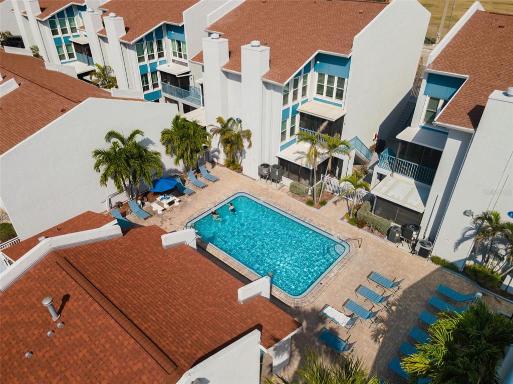337 Rex Place, Unit G Madeira Beach, FL 33708 - Photo 37 of 40 an aerial view of a house with a swimming pool