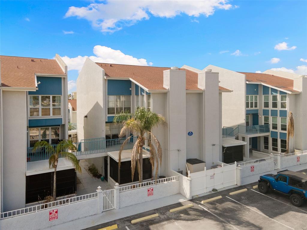 337 Rex Place, Unit G Madeira Beach, FL 33708 - Photo 39 of 40 a front view of a building with glass door and glass door