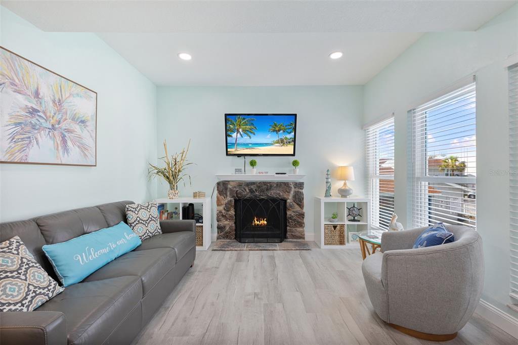 337 Rex Place, Unit G Madeira Beach, FL 33708 - Photo 4 of 40 a living room with furniture and a fireplace