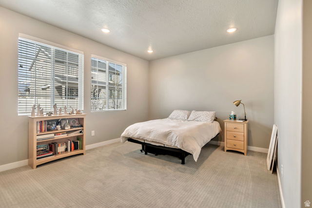 3232 West 1670th Street North Provo, UT 84601 - Photo 13 of 33 Bedroom featuring recessed lighting, light colored carpet, and a textured ceiling