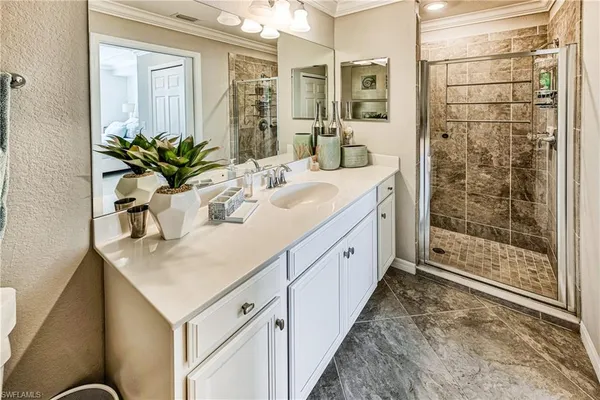 a spacious bathroom with a granite countertop sink and a mirror