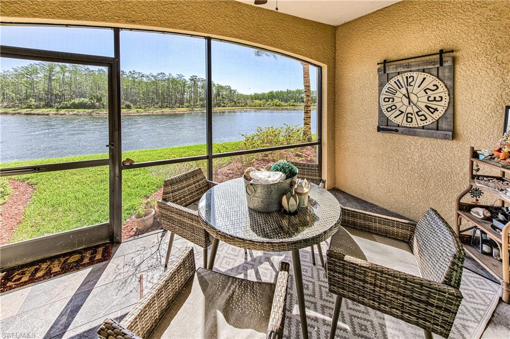 9572 Trevi Court, Unit 5015 Naples, FL 34113 - Photo 2 of 39 a dining room with furniture and a floor to ceiling window