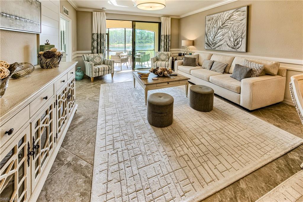 9572 Trevi Court, Unit 5015 Naples, FL 34113 - Photo 5 of 39 a living room with furniture and a flat screen tv