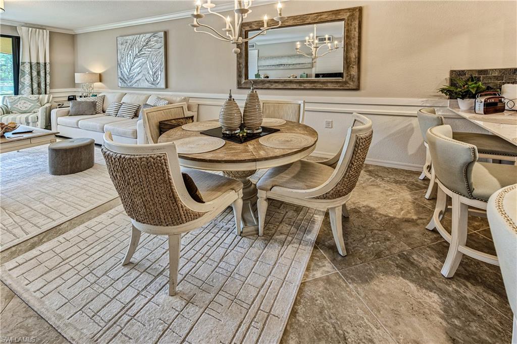 9572 Trevi Court, Unit 5015 Naples, FL 34113 - Photo 6 of 39 a dining room with furniture and wooden floor