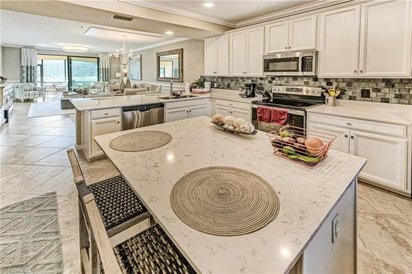 a bathroom with a granite countertop sink and a refrigerator