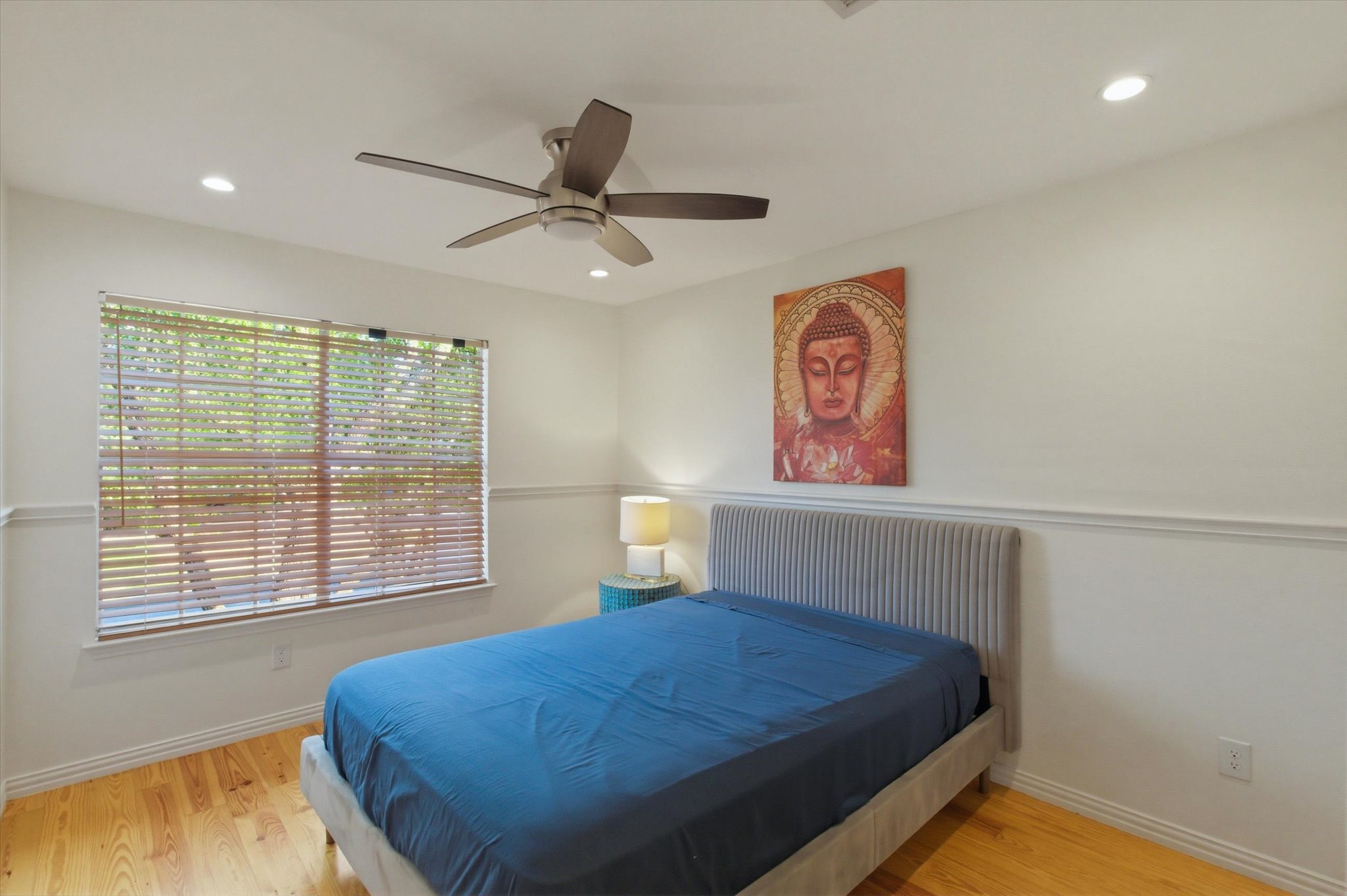 8920 West Hove Loop Austin, TX 78749 - Photo 17 of 39 Bright room featuring wood-finish flooring, a ceiling fan with integrated lighting, recessed lighting, and a large window with horizontal blinds