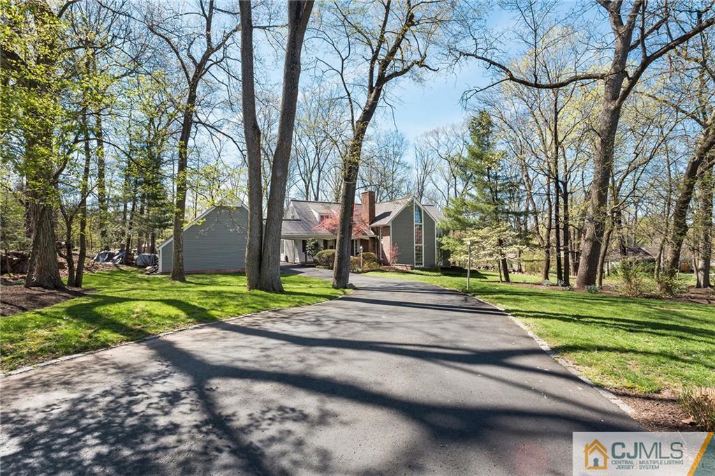 109 Rolling Hill Road Skillman, NJ 08558 - Photo 1 of 25 a view of road with large trees and a big yard