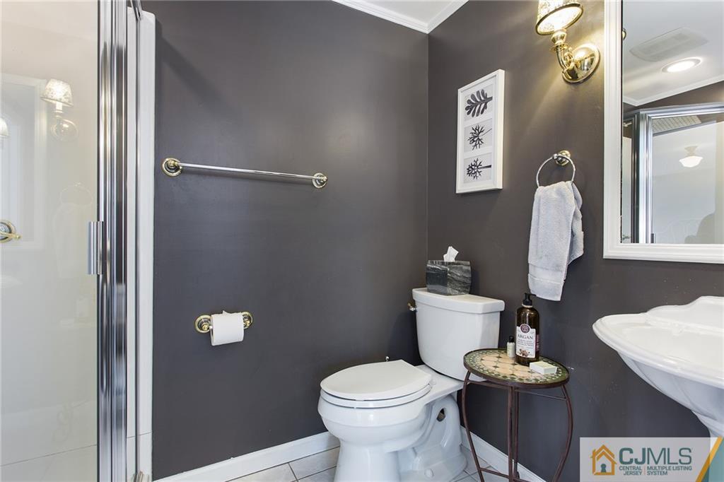 109 Rolling Hill Road Skillman, NJ 08558 - Photo 19 of 25 a white toilet sitting next to a bathroom sink
