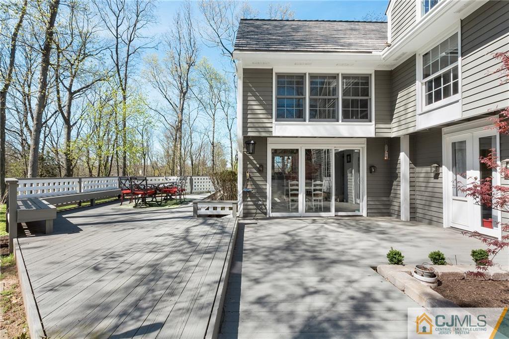 109 Rolling Hill Road Skillman, NJ 08558 - Photo 22 of 25 a view of a brick house with many windows and a tree