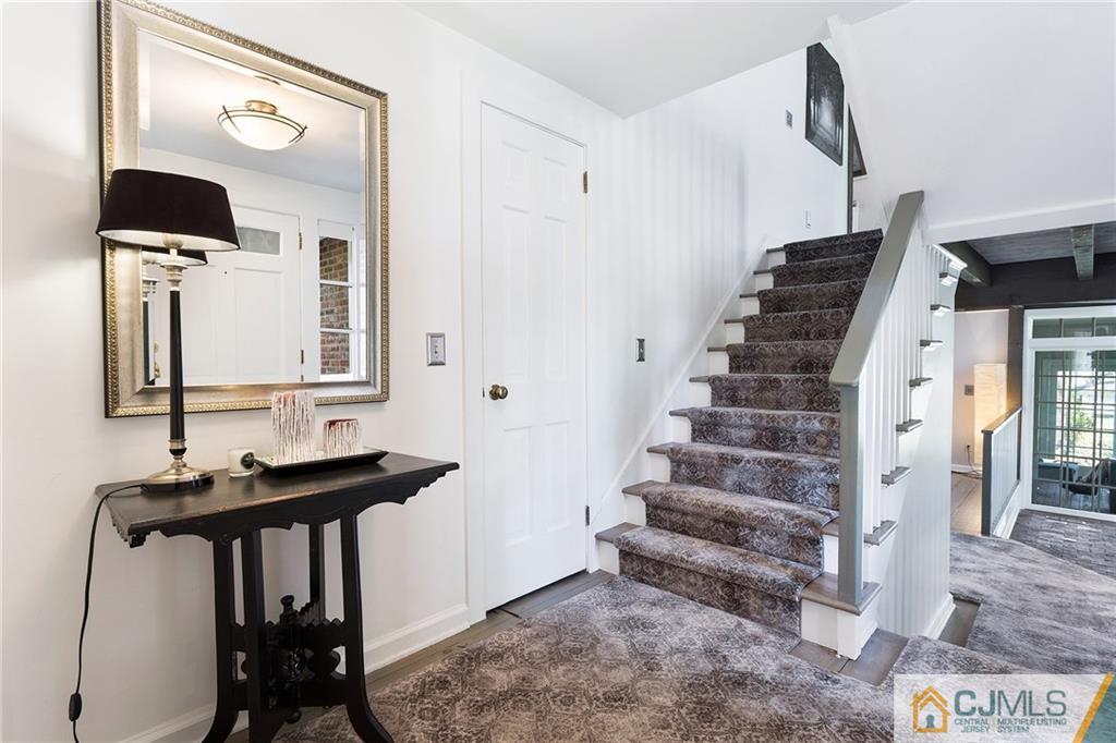 109 Rolling Hill Road Skillman, NJ 08558 - Photo 4 of 25 a view of a hallway with front door and wooden floor