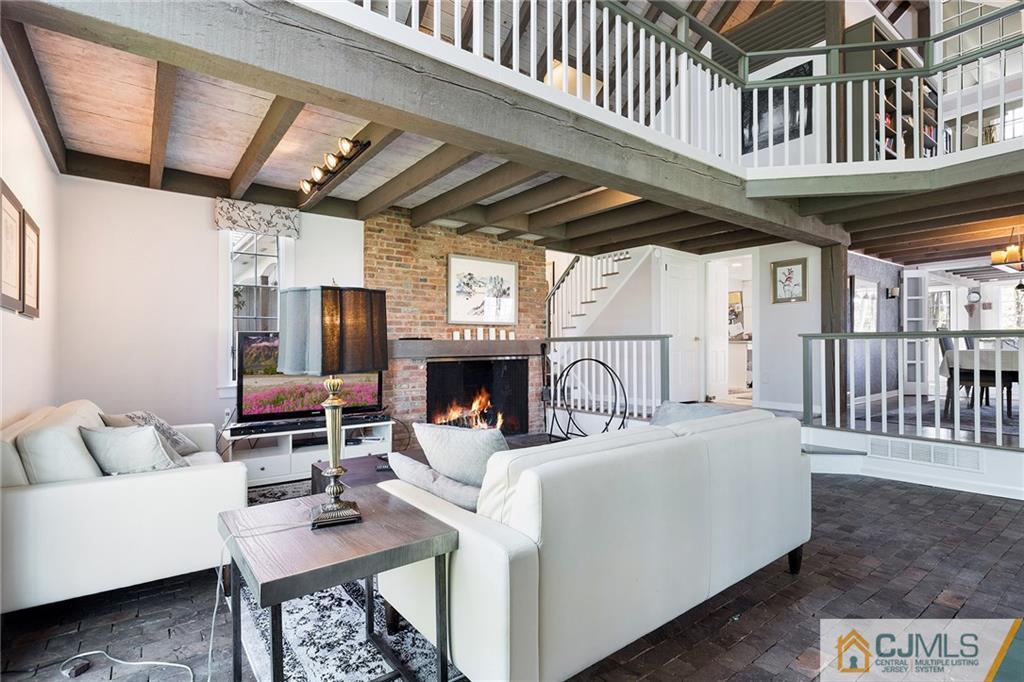 109 Rolling Hill Road Skillman, NJ 08558 - Photo 5 of 25 a living room with furniture a fireplace and a flat screen tv