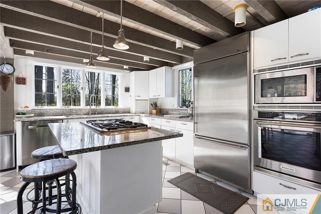 109 Rolling Hill Road Skillman, NJ 08558 - Photo 10 of 25 a kitchen with stainless steel appliances granite countertop a stove a refrigerator and a microwave