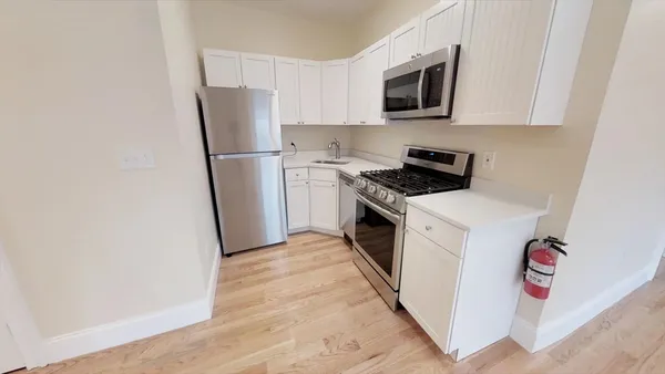 a kitchen with a refrigerator stove and microwave