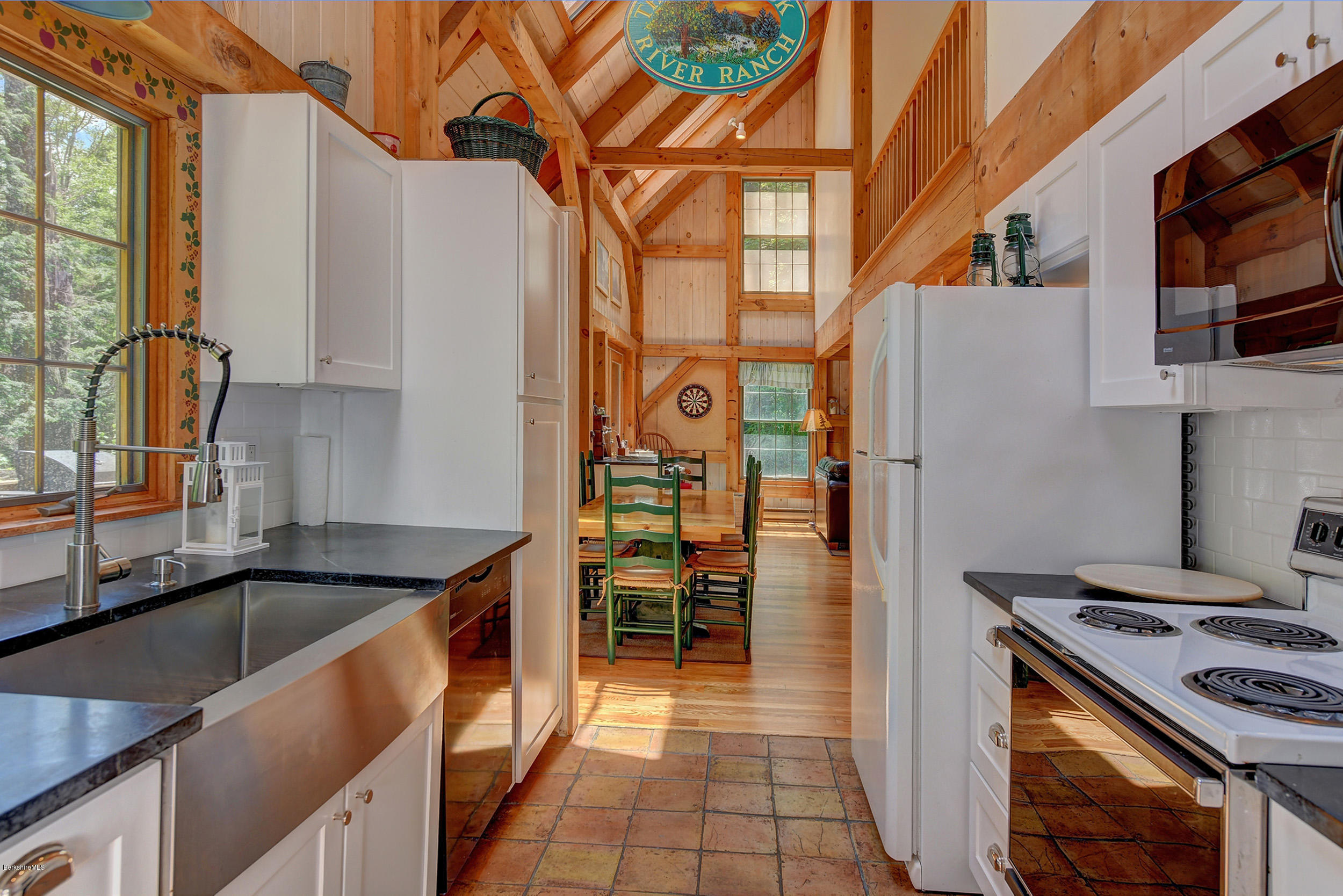 726 North Main Road Otis, MA 01253 - Photo 12 of 30 a kitchen with stainless steel appliances granite countertop a sink and a stove