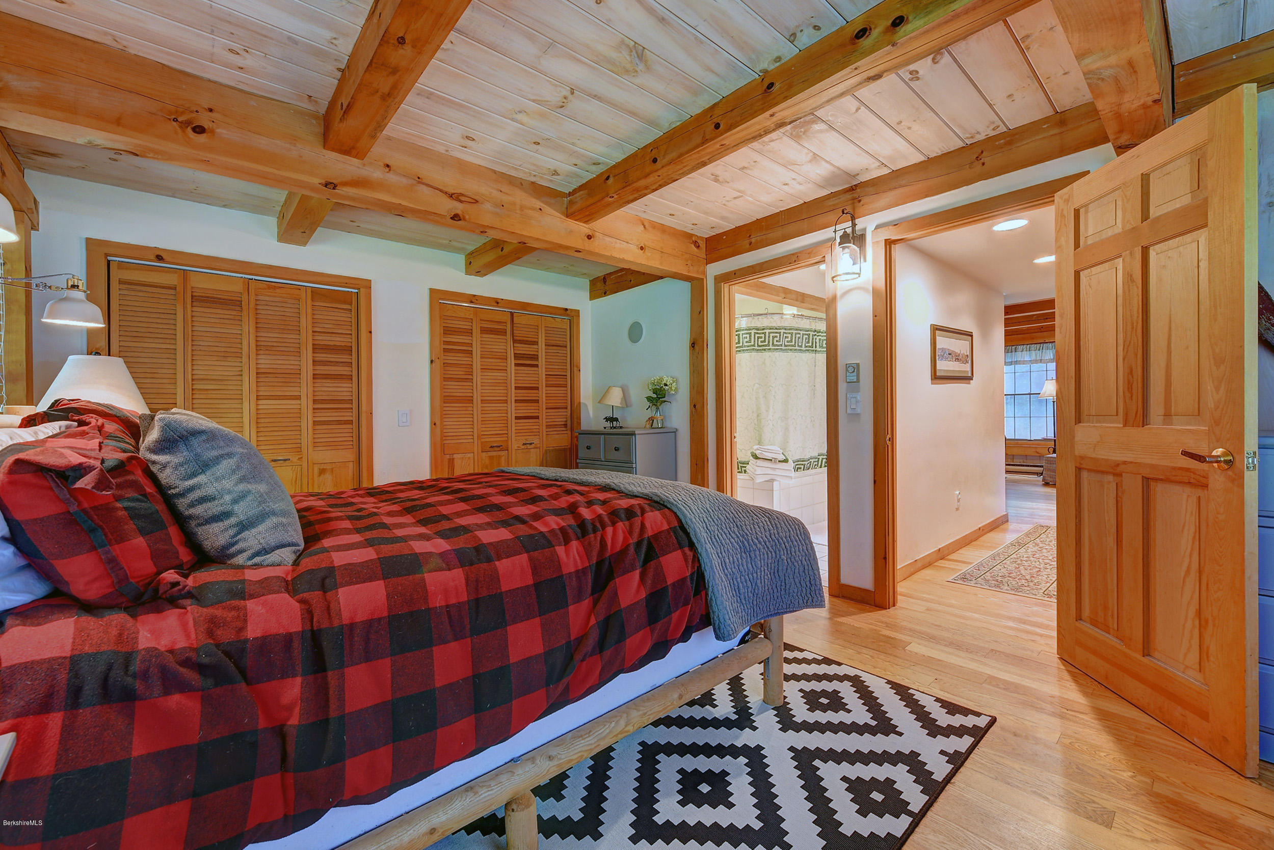 726 North Main Road Otis, MA 01253 - Photo 14 of 30 a bedroom with a bed a dresser and a large window