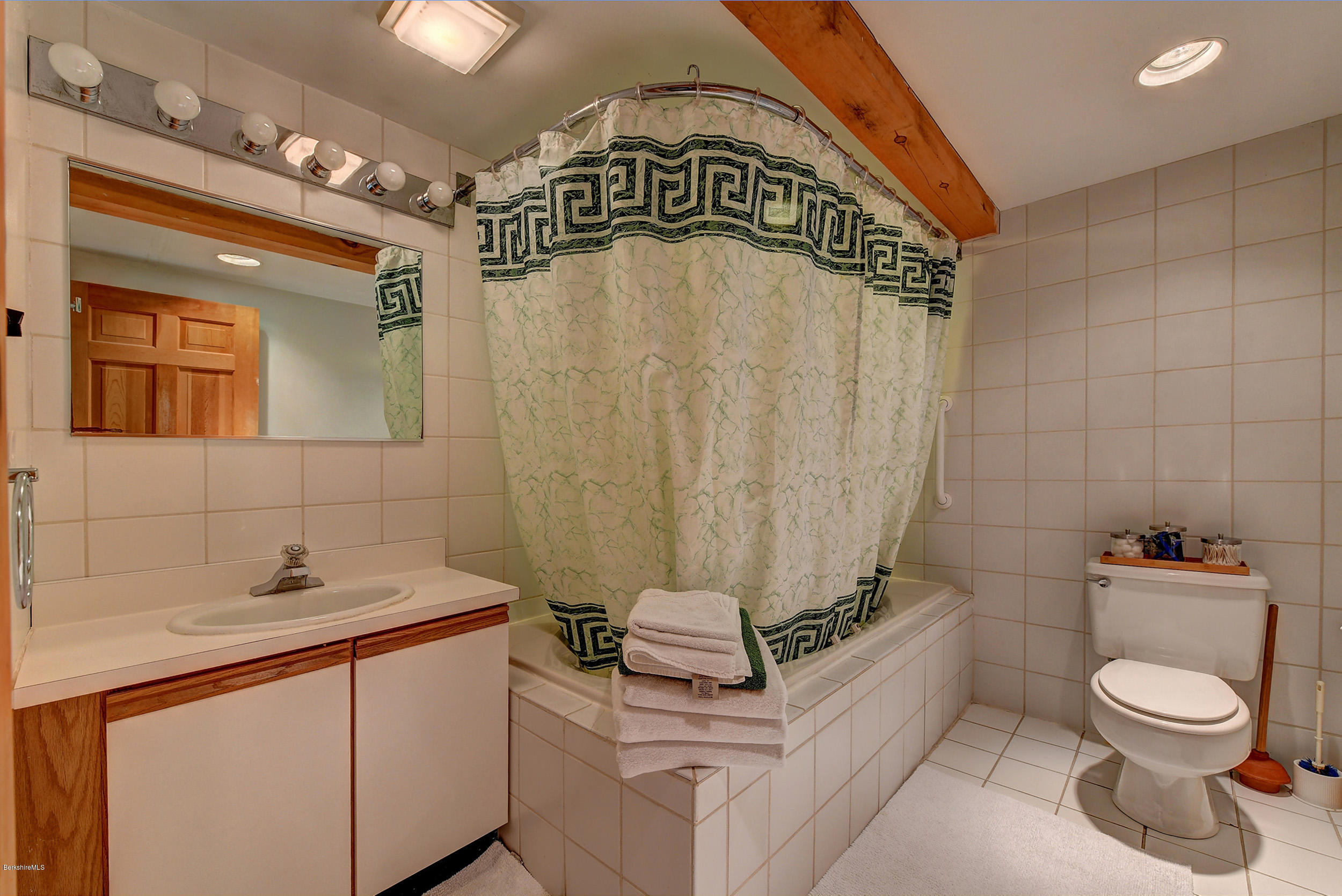 726 North Main Road Otis, MA 01253 - Photo 15 of 30 a bathroom with a granite countertop sink a toilet and mirror