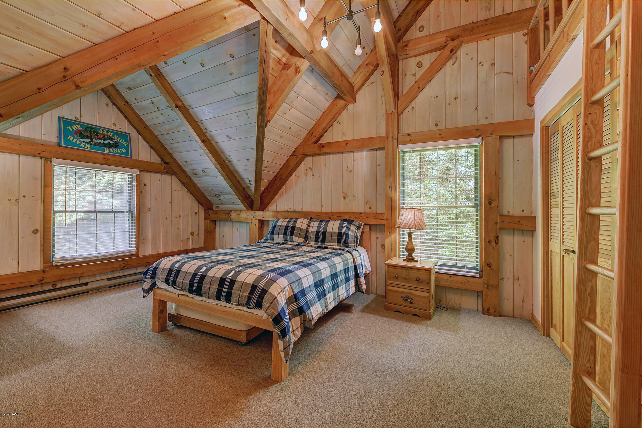 726 North Main Road Otis, MA 01253 - Photo 17 of 30 a bed sitting in a spacious bedroom next to a window