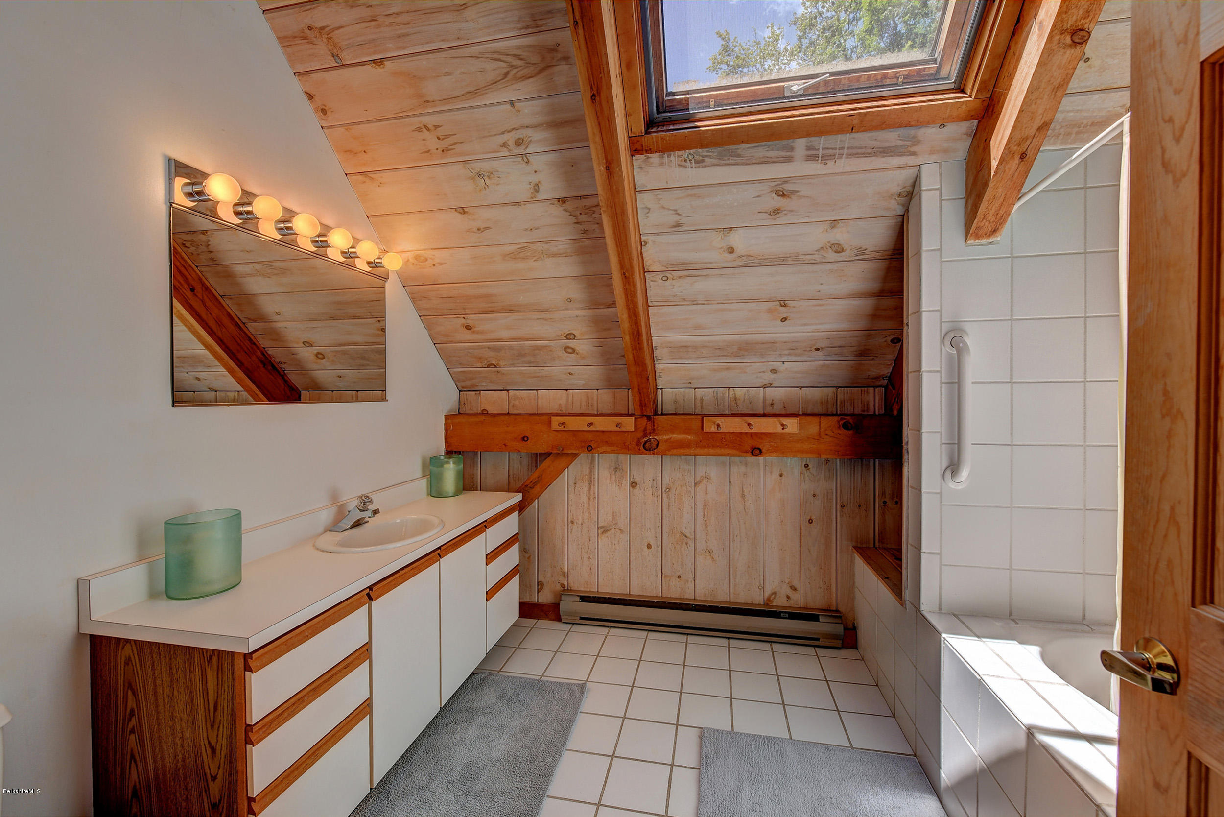 726 North Main Road Otis, MA 01253 - Photo 21 of 30 a bathroom with a sink a mirror and a shower