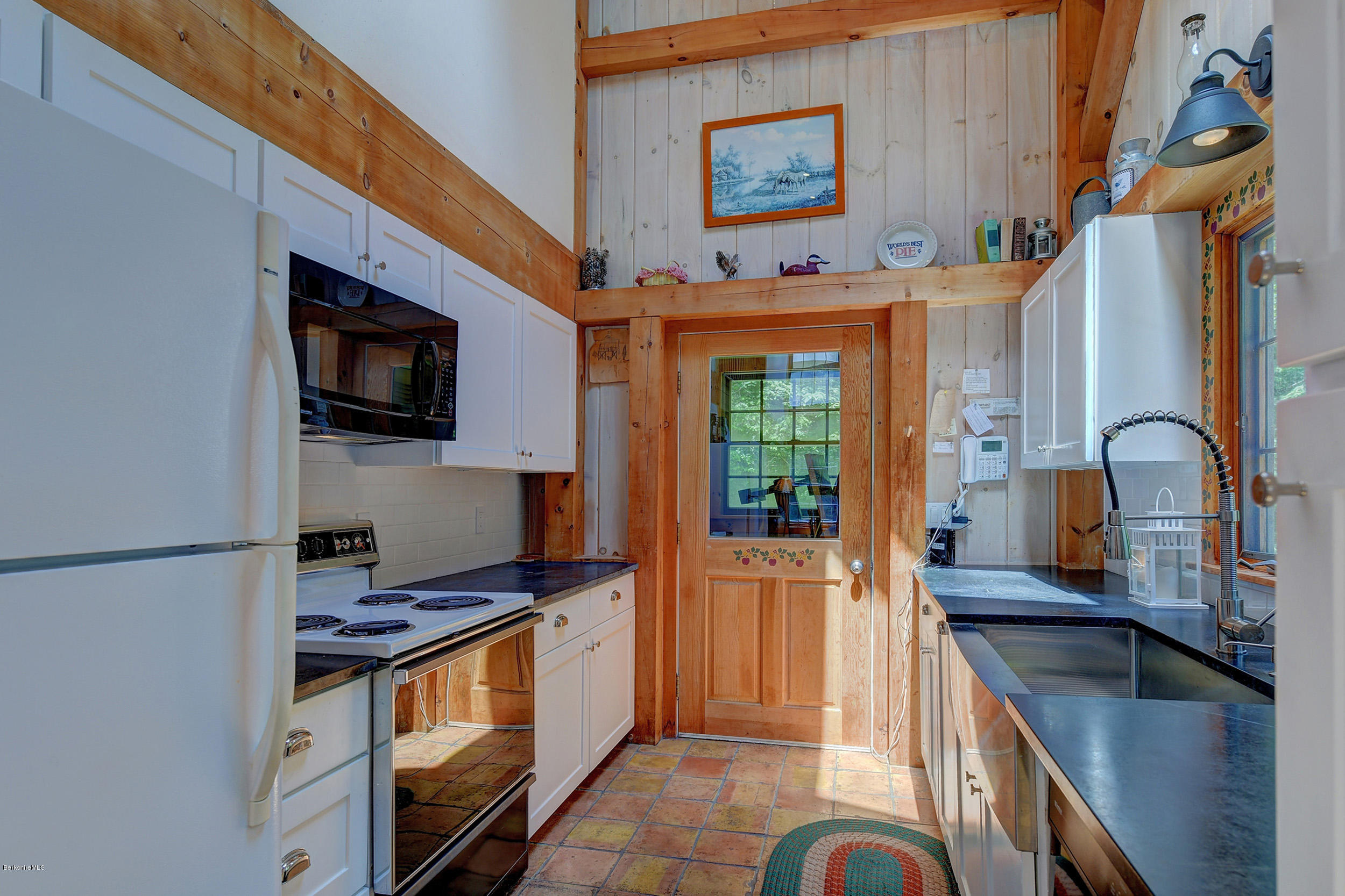 726 North Main Road Otis, MA 01253 - Photo 10 of 30 a kitchen with granite countertop a sink and a stove top oven