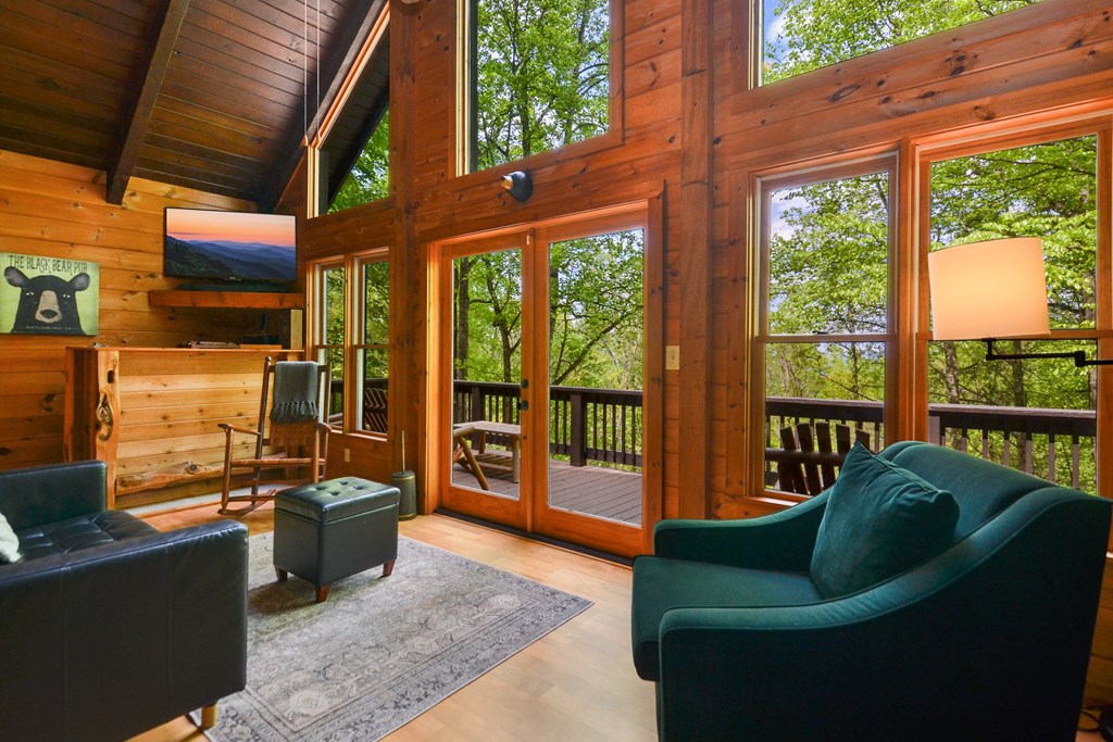 1213 Mountain Oak Road Ellijay, GA 30536 - Photo 30 of 65 a living room with patio furniture and a floor to ceiling window